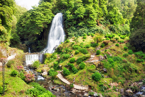 Waterfall at Ribeira dos Caldeirões in Nordeste with tourists, Sao Miguel island in the Azores.