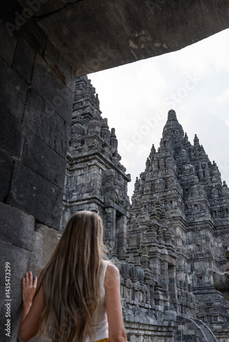 Tourist woman admiring prambanan temple complex in yogyakarta, indonesia