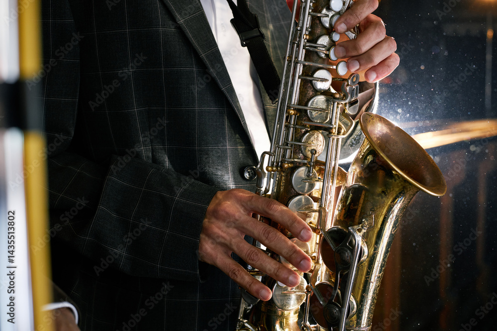 Obraz premium Cropped shot of saxophonist performing jazz music on brass instrument pressing keys during live performance at bar