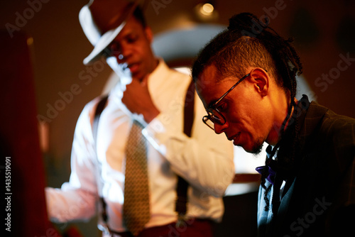 Canvas Print Side view of multiracial male musician wearing glasses playing piano with profes