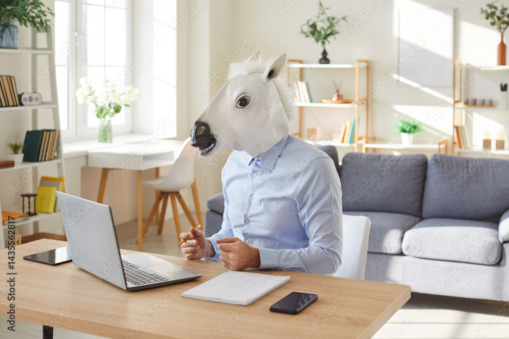 Funny extravagant happy man wearing donkey, horse head working online at desk to enjoy showing impressive achievements, successful deal, cute amuse guy playing, business worker at computer working