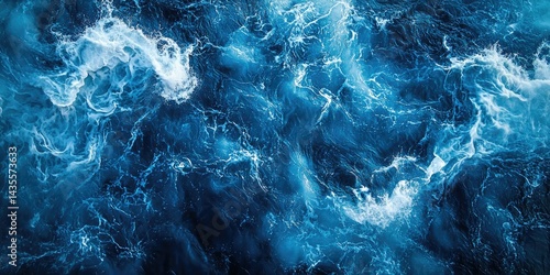 An aerial view capturing the swirling, foamy wake of a boat cutting through deep blue waters.