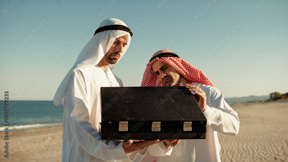 Two Sheiks Opening The Briefcase Near The Sea
