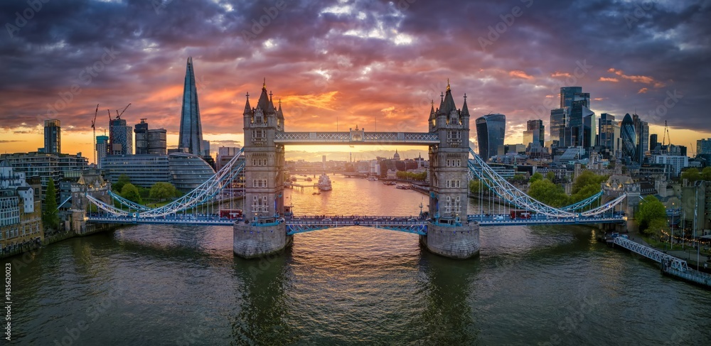 Panoramic, aerial view of the Tower Bridge and skyline of London, United Kingdom, during a beautiful sunset