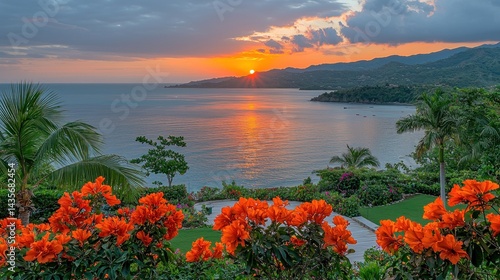 Fototapeta Naklejka Na Ścianę i Meble -  Tropical ocean sunset with bright orange flowers