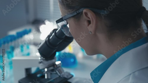 Wallpaper Mural A passionate female scientist inspects samples with a microscope, surrounded by blue glassware and lab equipment, focusing on her groundbreaking research and innovations in biotechnology Torontodigital.ca