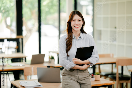 Confident Asian female employee smiling brightly looking at camera The concept of a self-confident young woman