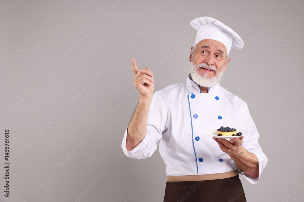 Professional pastry chef with delicious tart on grey background, space for text Professional pastry chef with delicious tart on grey background, space for text