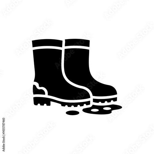 Farm Boots Next to Puddle with Muddy Soles