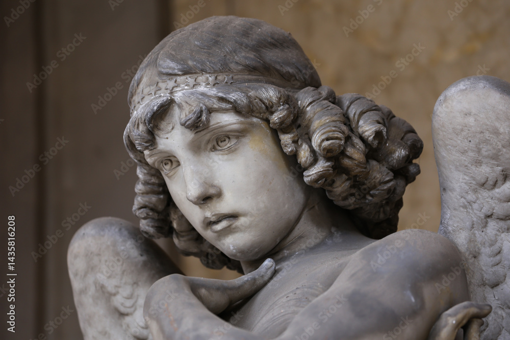 Guardian angel statue in antique cemetery.