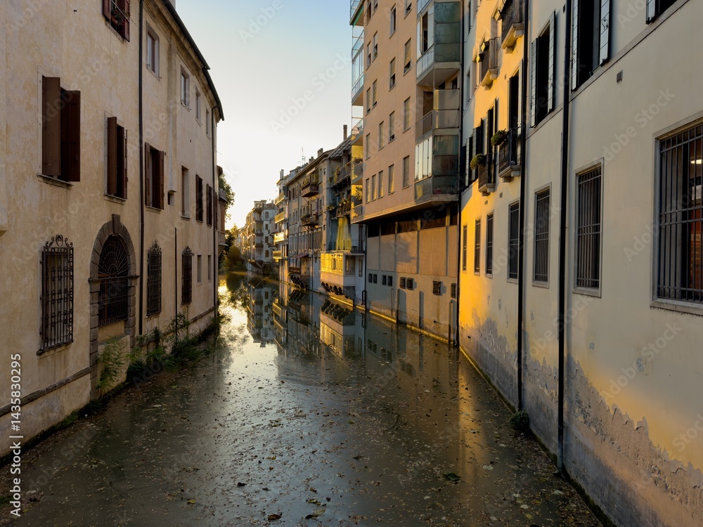 Naviglio Interno water canal in Padova, Italy at sunset, full of trash