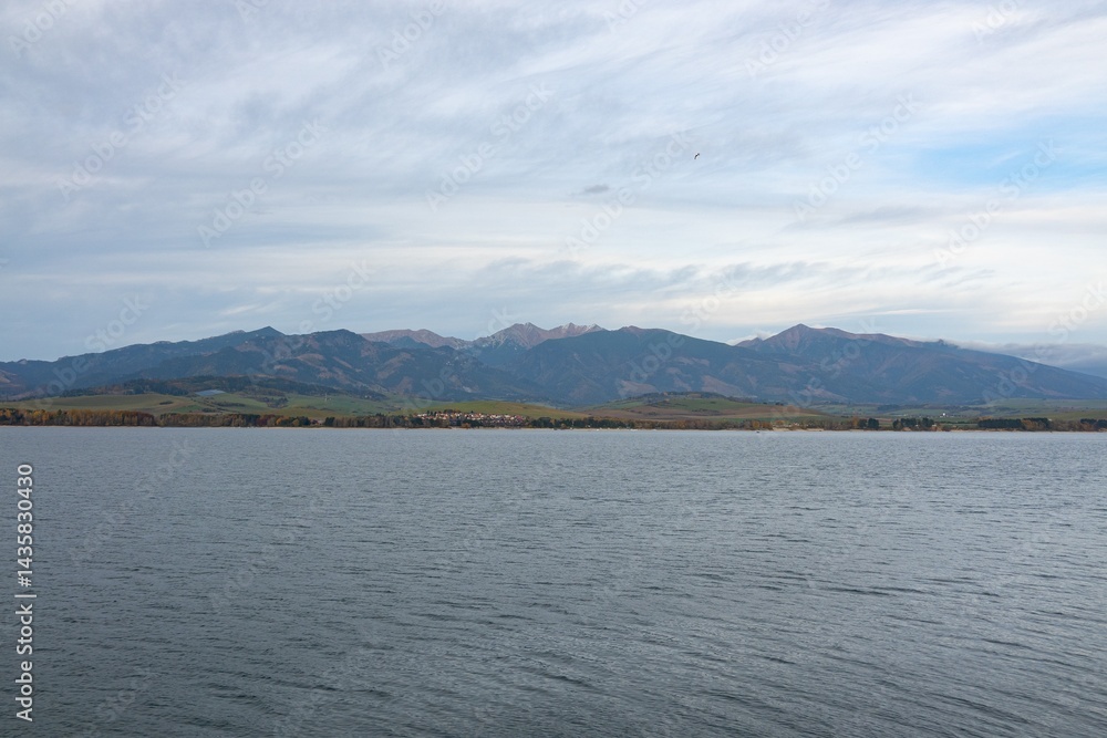 Landscape of Liptovska Mara water dam in Slovakia, High Tatra Mountains in background