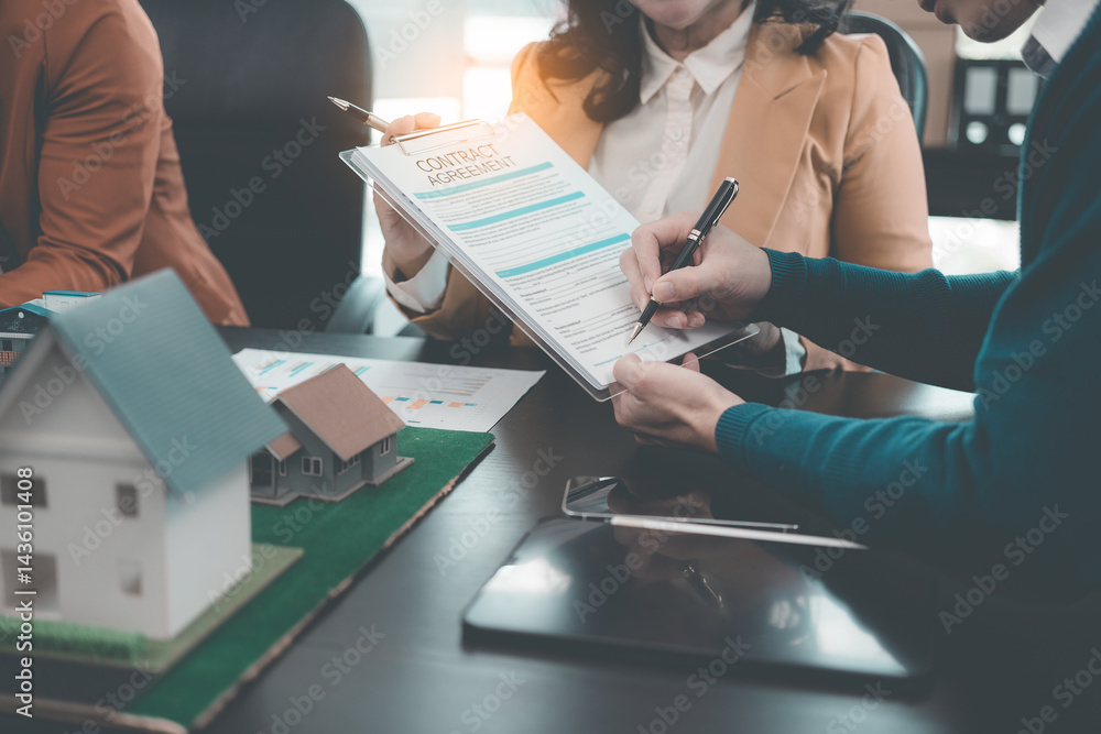 Business team signing investment agreement for residential real estate. Group of professionals in suits meeting in office with financial agreement documents on table.