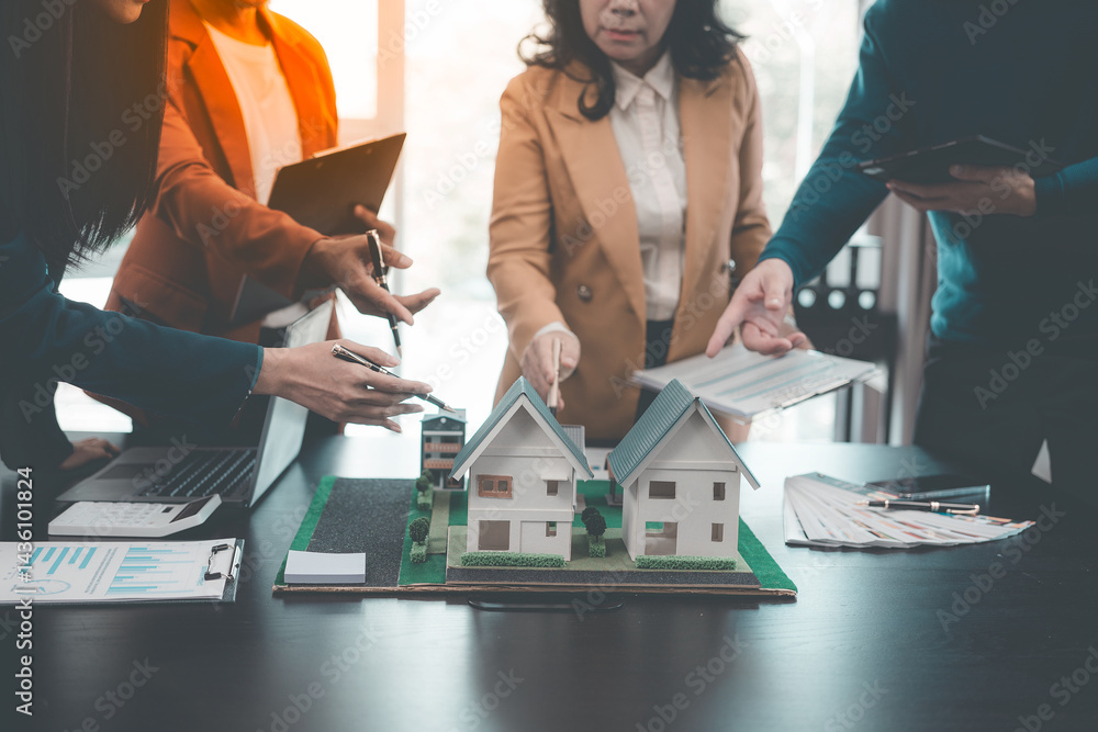 Business team signing investment agreement for residential real estate. Group of professionals in suits meeting in office with financial agreement documents on table.