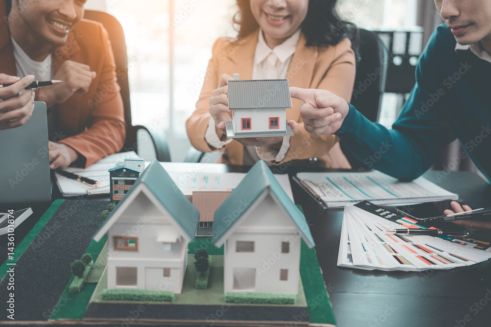 Business team signing investment agreement for residential real estate. Group of professionals in suits meeting in office with financial agreement documents on table.