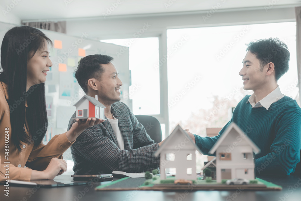 Business team signing investment agreement for residential real estate. Group of professionals in suits meeting in office with financial agreement documents on table.