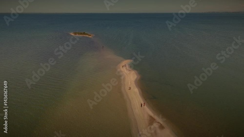 Drone view of a serene lake with an island, revealing its stunning 