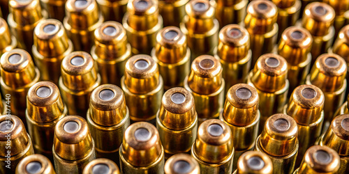 Cartridge casings are densely packed together, highlighting their brass color and unique shapes. This close-up emphasizes the precision in ammunition manufacturing