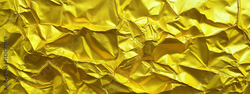 Rich gold foil textured surface with artistic folds and shiny metallic reflections, luxurious abstract golden background banner