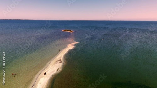 Drone view of a serene lake with an island, revealing its stunning 