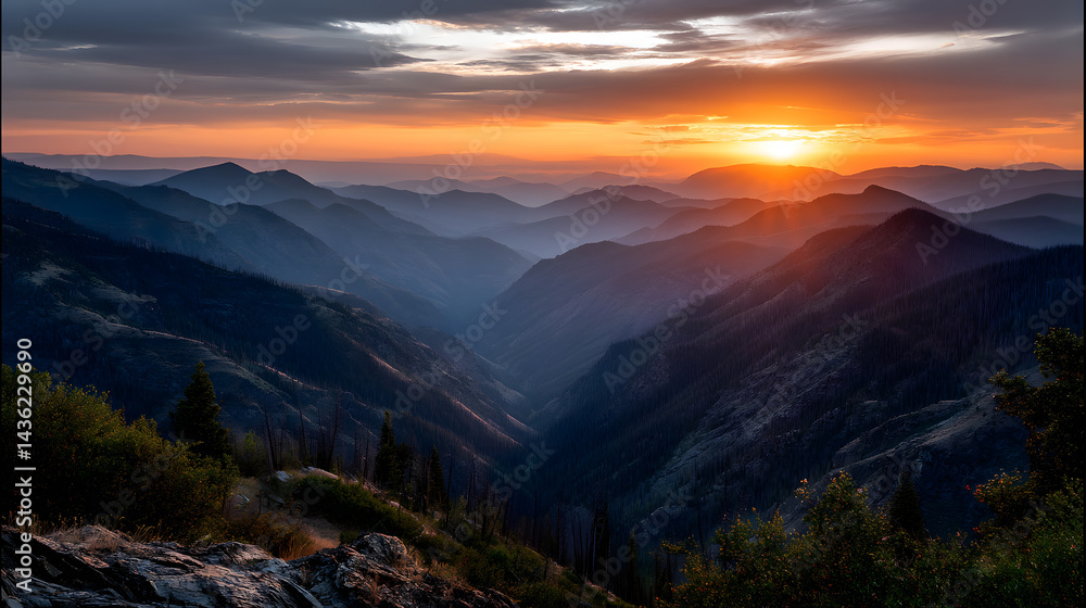 The last rays of the orange sunset casting a peaceful glow over the mountain tops and valleys below. The last rays of the orange sunset casting a peaceful glow over the mountain tops and valleys below.