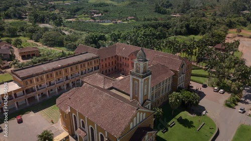 Drone captures a historic church and convent nestled amidst lush tropical mountains. Spiritual sanctuary in nature's embrace