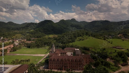 Wallpaper Mural Drone captures a historic church and convent nestled amidst lush tropical mountains. Spiritual sanctuary in nature's embrace Torontodigital.ca