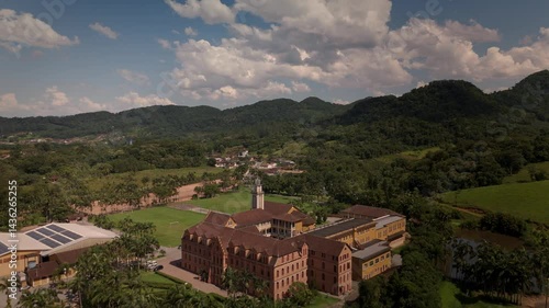 Drone captures a historic church and convent nestled amidst lush tropical mountains. Spiritual sanctuary in nature's embrace