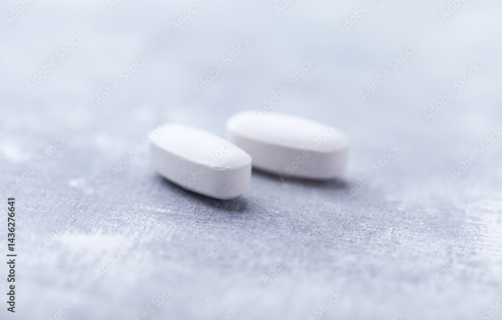 Amino acids tablets on wooden background. Soft focus. Close up Amino acids tablets on wooden background. Soft focus. Close up