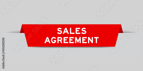 Red color inserted label with word sales agreement on gray background