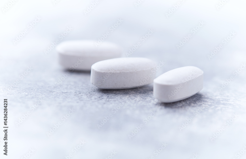 Amino acids tablets on wooden background. Soft focus. Close up Amino acids tablets on wooden background. Soft focus. Close up