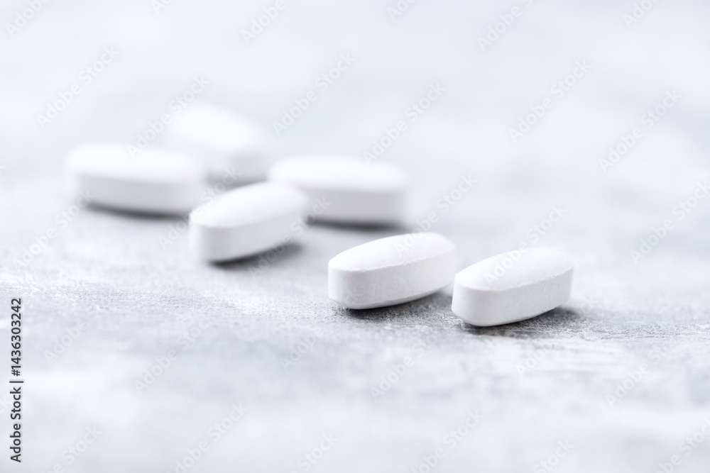 Amino acids tablets on wooden background. Soft focus. Close up Amino acids tablets on wooden background. Soft focus. Close up
