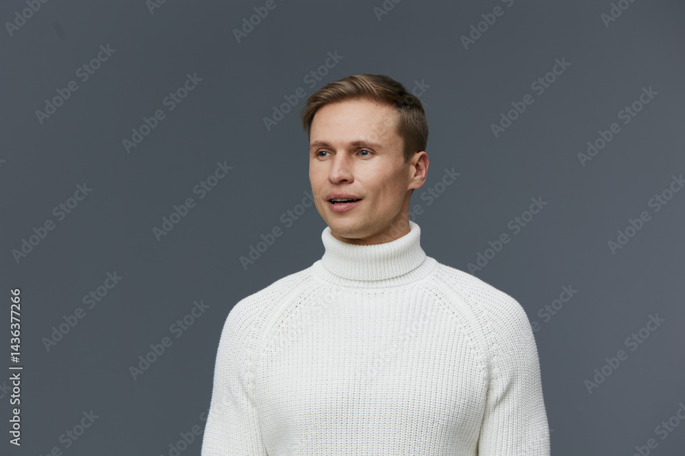 Caucasian man wearing white turtleneck sweater look aside smiling studio portrait gray background work mental health gadgets concept Caucasian man wearing white turtleneck sweater look aside smiling studio portrait gray background work mental health gadgets concept