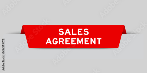 Red color inserted label with word sales agreement on gray background