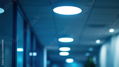 Modern Office Interior with Circular LED Ceiling Lights at Night