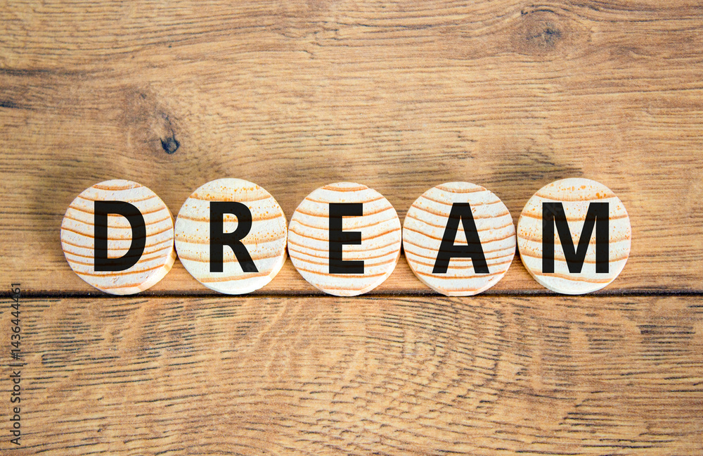 Fototapeta premium Dream symbol. Concept word Dream on beautiful wooden circles. Beautiful wooden table wooden background. Business lifestyle dream concept. Copy space.
