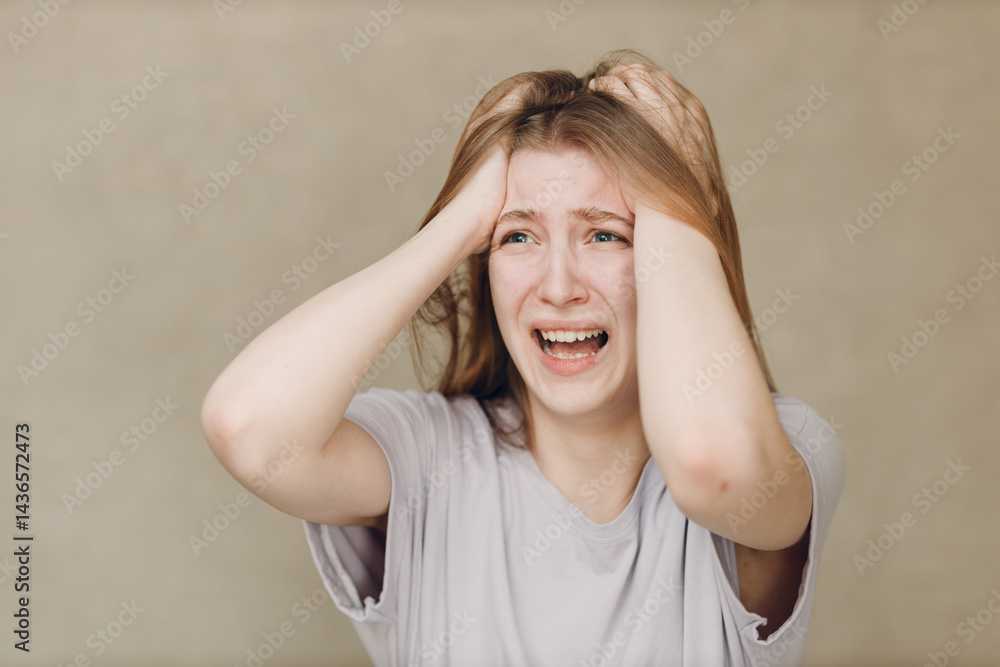 Portrait of young caucasian actress crying upset woman looking at camera against beige background. Acting test casting audition