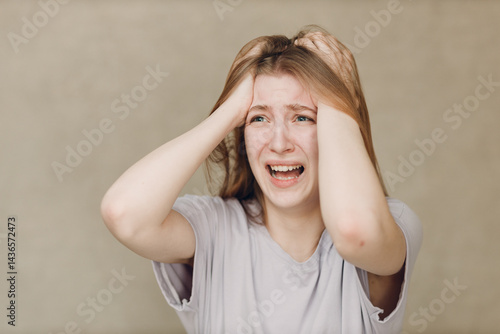 Obraz na płótnie Portrait of young caucasian actress crying upset woman looking at camera against beige background. Acting test casting audition w salonie