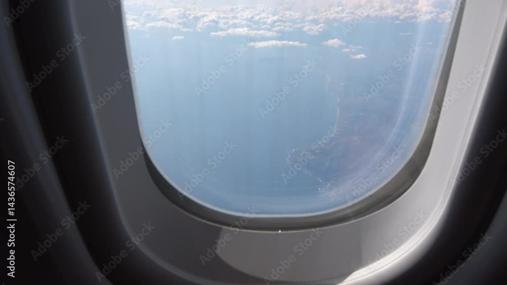 Airplane cabin view: Plane flying over the coastline, approaching land. Airplane cabin view: Plane flying over the coastline, approaching land.