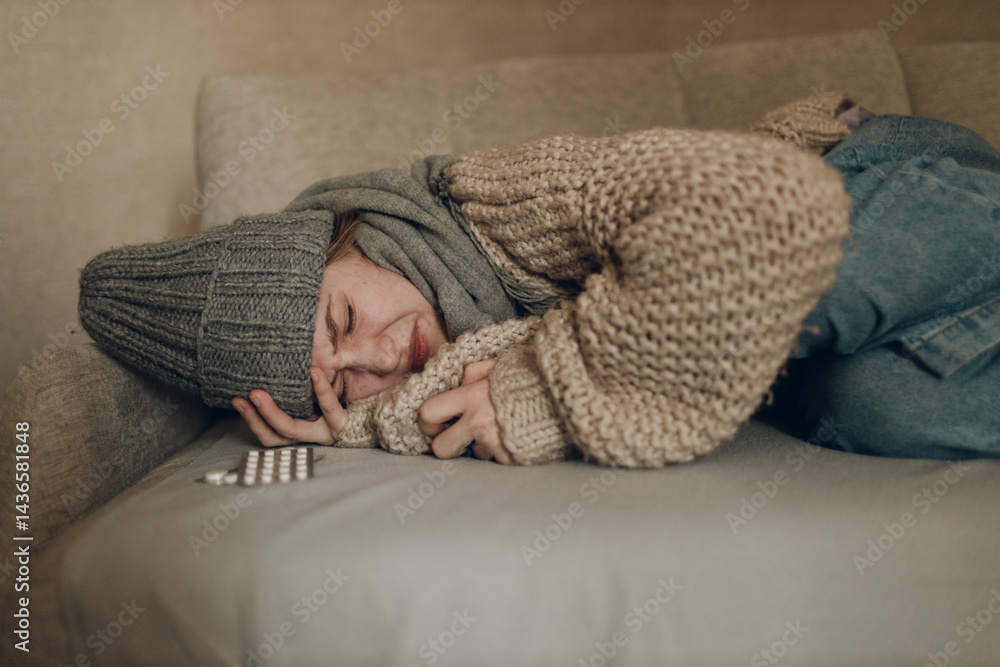 Young woman wearing scarf has flu ill sick disease cold at home indoor on sofa