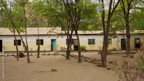 Empty school ground and buildings in village or town in Africa during summer. No kids or students. Break or vacation in Tanzania elementary school. Hot day outdoors in humble conditions