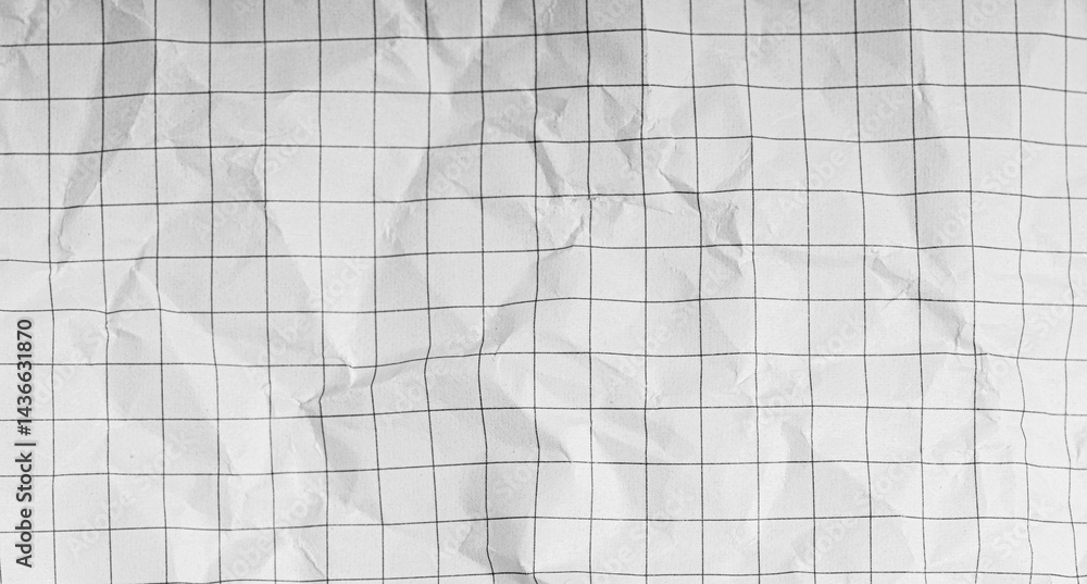 Plaid texture on crumpled white paper. A sheet of chequered paper on a white background