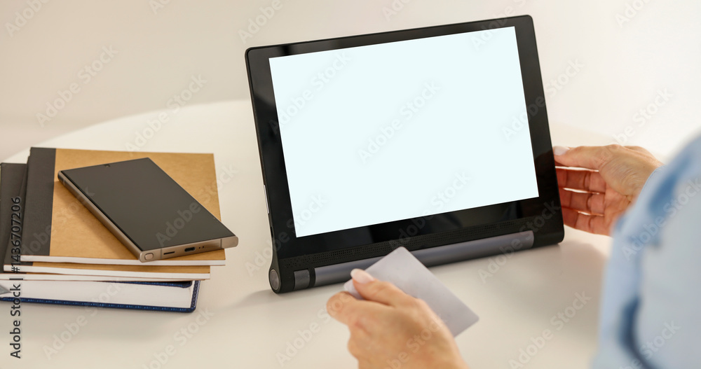 Close-up for female hand holding credit card for online shopping, browsing e-commerce website on tablet and smartphone. Close-up for female hand holding credit card for online shopping, browsing e-commerce website on tablet and smartphone.