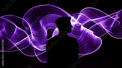 Silhouette of a person against a backdrop of flowing purple light waves on a dark black background.