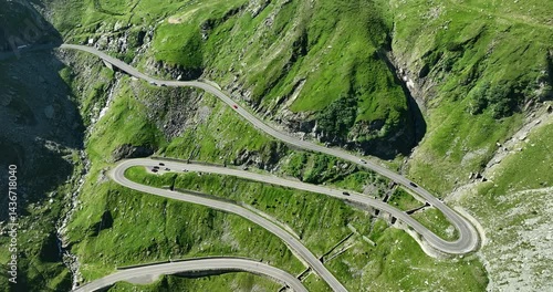Reverse tracking aerial drone motion of the Transfagarasan Highway, mountain road on the Carpathian Mountains, one of the 10 most beautiful roads in the world, Romania, Eastern Europe