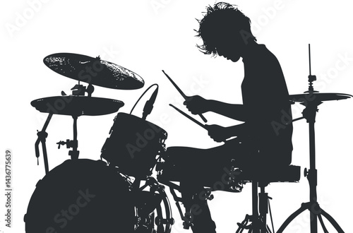 Silhouette of a young drummer playing a drum set with drumsticks in a music performance