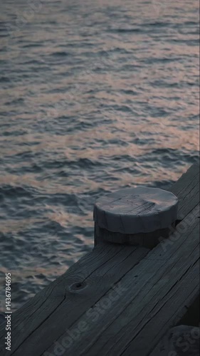 A tranquil close-up of water reflecting the golden glow of a sunset, with gentle ripples creating a shimmering effect. Perfect for nature and serenity-themed projects.