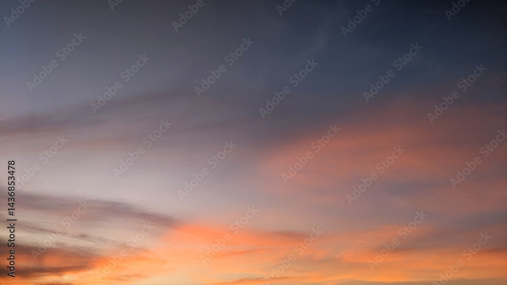 A dramatic sky in Indonesia features dark, textured clouds contrasted by patches of vibrant orange and hints of blue peeking through. A dramatic sky in Indonesia features dark, textured clouds contrasted by patches of vibrant orange and hints of blue peeking through.