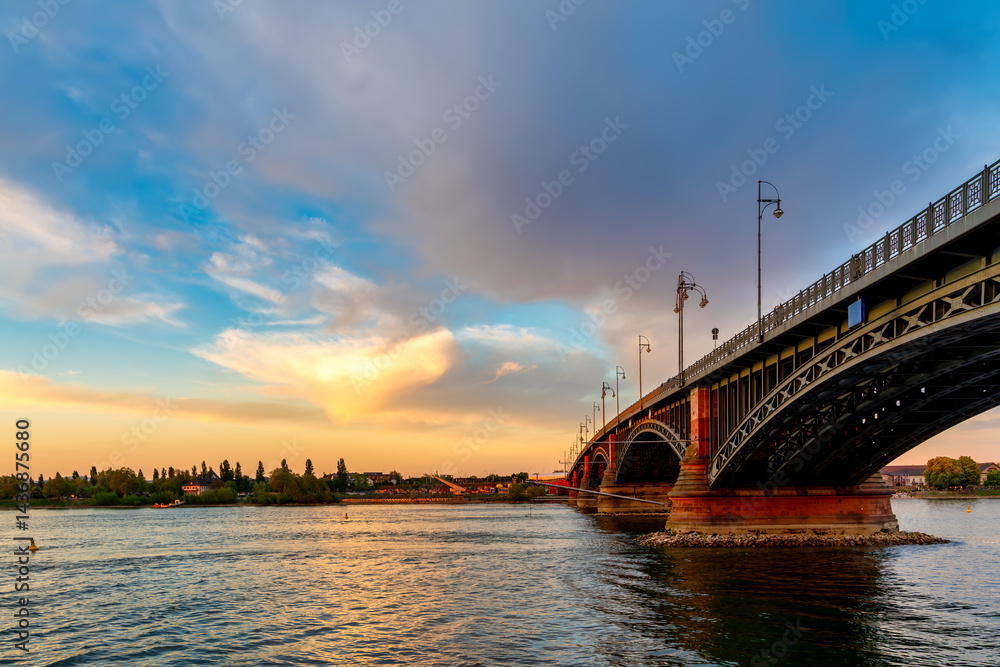 Historic bridge over the Rhine River in Mainz at sunset, Germany