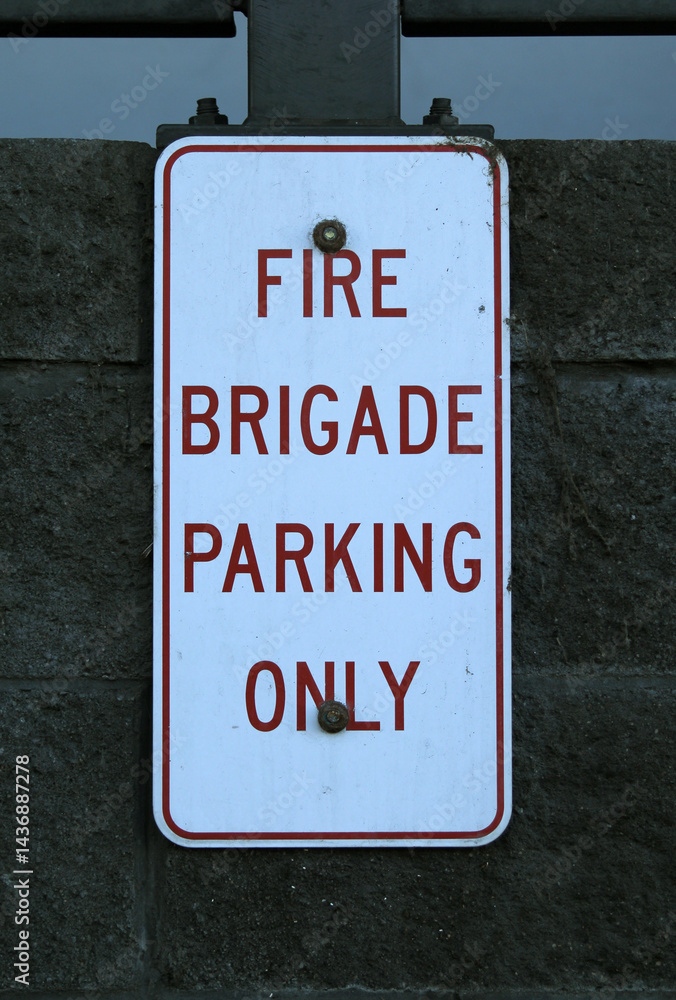 Obraz premium Fire Brigade Parking Only sign attached to a brick wall